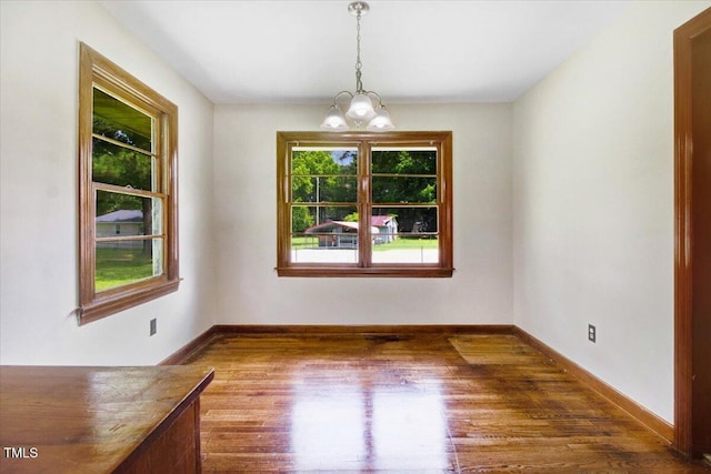 325 Bell St, Enfield, NC 27823 - unfurnished dining area with wood finished floors and a chandelier