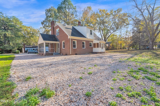 view of side of property featuring a sunroom