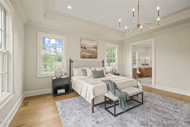 bedroom featuring light wood-type flooring, visible vents, crown molding, a raised ceiling, and a notable chandelier