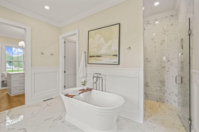 full bath with a wainscoted wall, visible vents, crown molding, a shower stall, and a freestanding tub