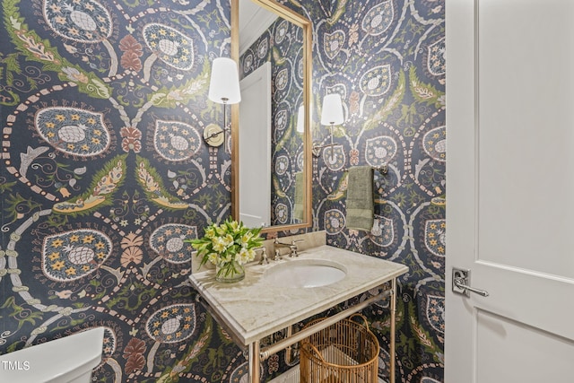 half bathroom with vanity and toilet