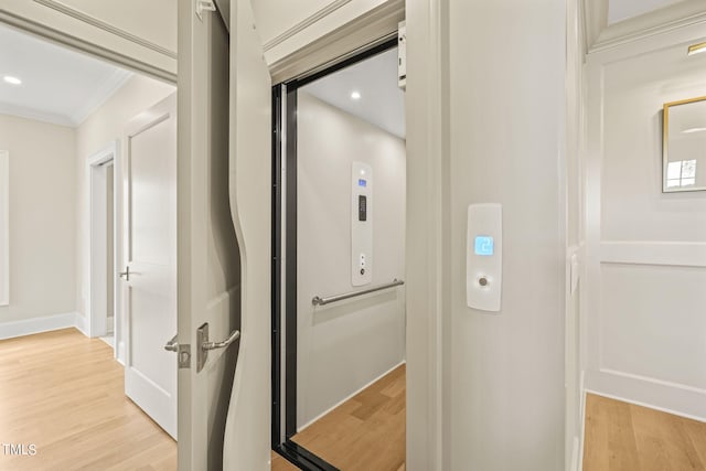 interior space featuring ornamental molding, recessed lighting, elevator, and wood finished floors