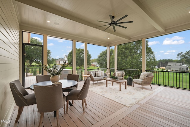 sunroom / solarium with an outdoor living space, a deck, ceiling fan, and beam ceiling