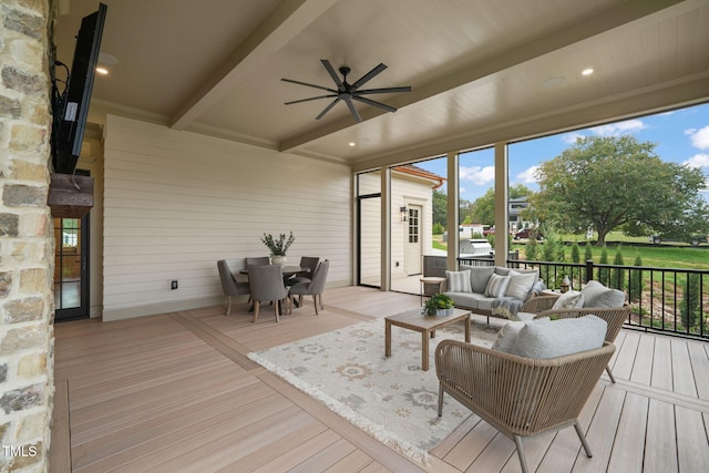 sunroom with beamed ceiling, outdoor dining area, a ceiling fan, and an outdoor living space