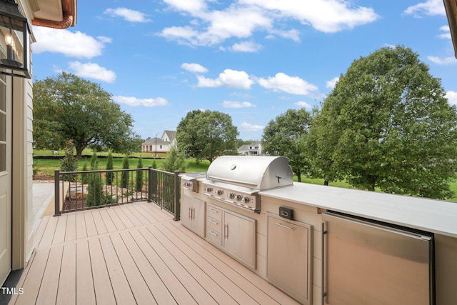 wooden deck featuring area for grilling and a grill
