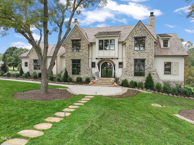 view of front of house featuring a front lawn and french doors