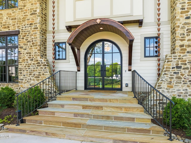 property entrance with stone siding