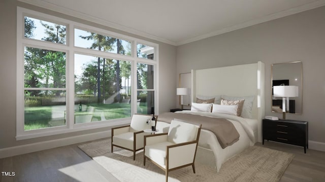 bedroom featuring light wood-style flooring, baseboards, and crown molding