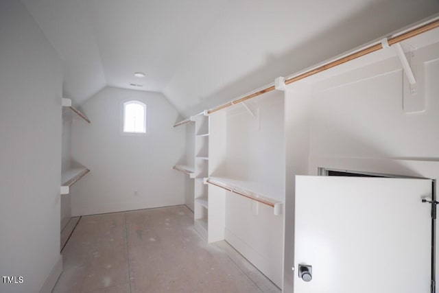 walk in closet with vaulted ceiling