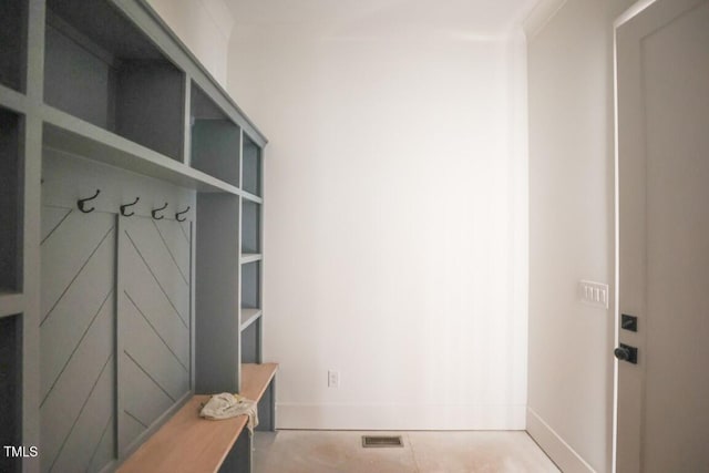 mudroom featuring built in shelves and light tile patterned flooring