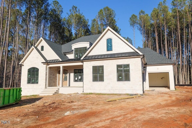 view of front of home featuring covered porch and a garage