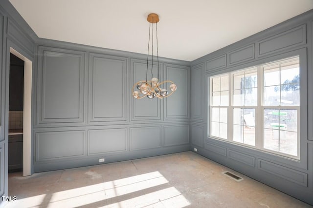 unfurnished dining area with a chandelier