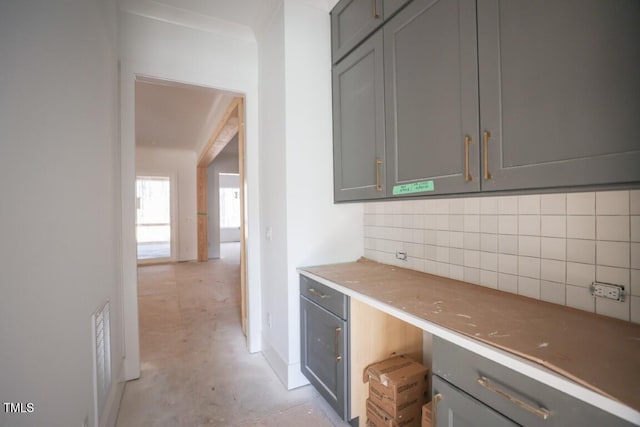 kitchen featuring backsplash and gray cabinets