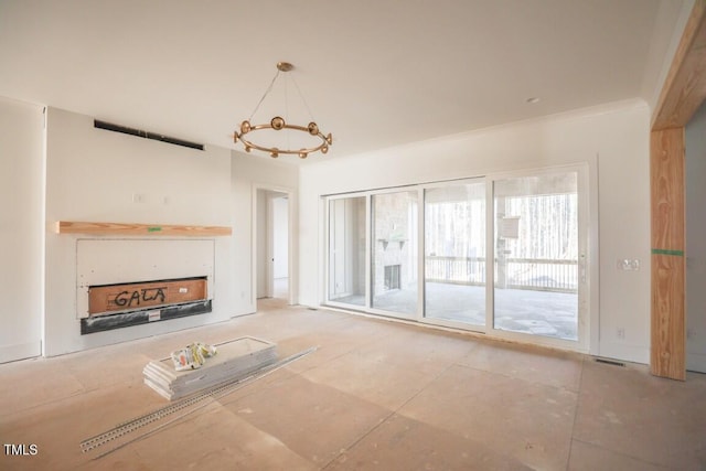 unfurnished living room featuring an inviting chandelier