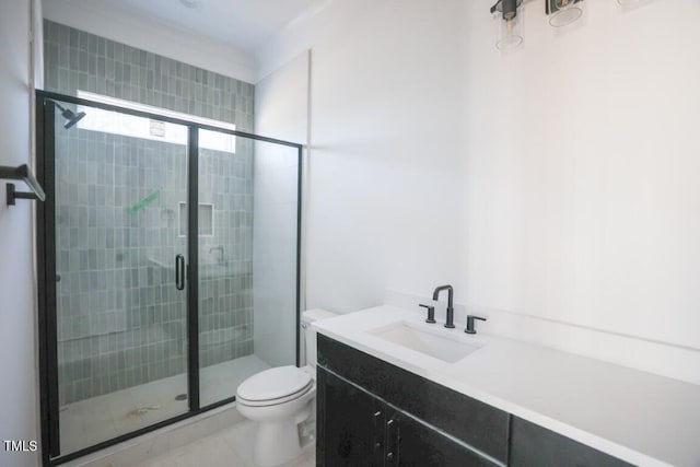 bathroom featuring tile patterned floors, vanity, toilet, and a shower with shower door