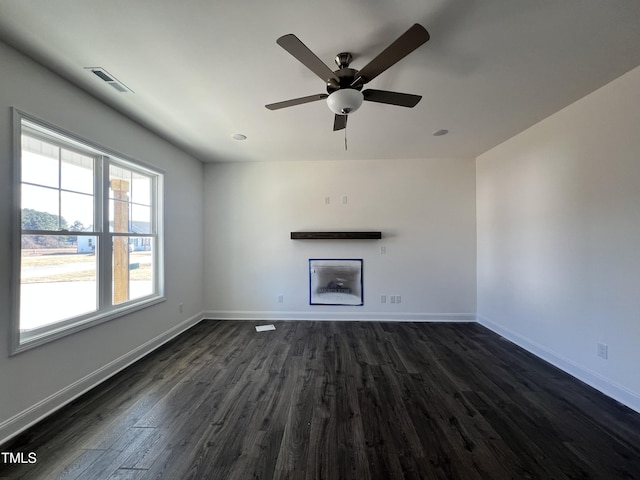 unfurnished living room with ceiling fan and dark hardwood / wood-style flooring