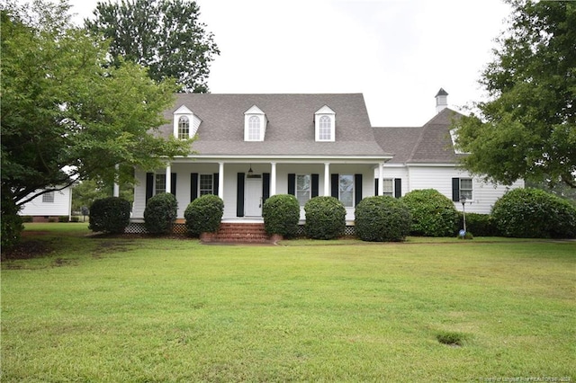 cape cod-style house featuring a front yard and a porch