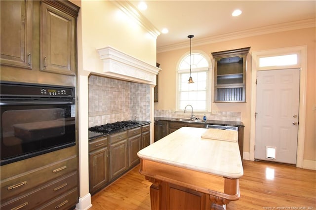 kitchen featuring dark brown cabinetry, sink, and appliances with stainless steel finishes