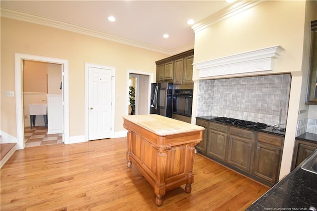 kitchen with stainless steel refrigerator with ice dispenser, light wood-type flooring, tasteful backsplash, ornamental molding, and black oven