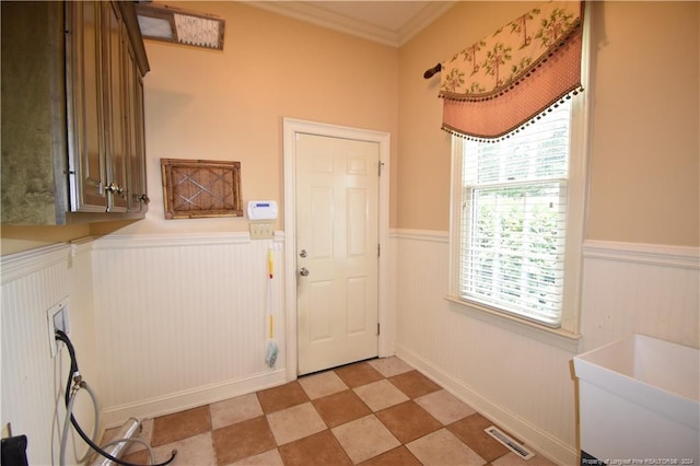 washroom with cabinets and ornamental molding