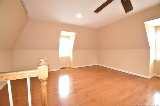 additional living space with ceiling fan, lofted ceiling, and hardwood / wood-style flooring