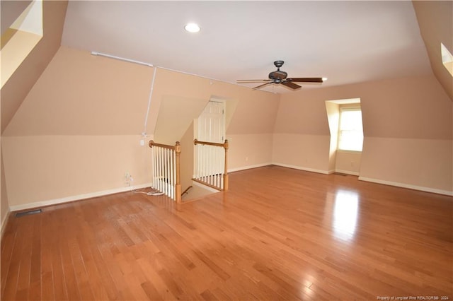 additional living space with ceiling fan and wood-type flooring