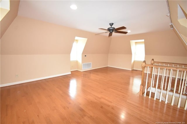 additional living space featuring light hardwood / wood-style floors, ceiling fan, and lofted ceiling