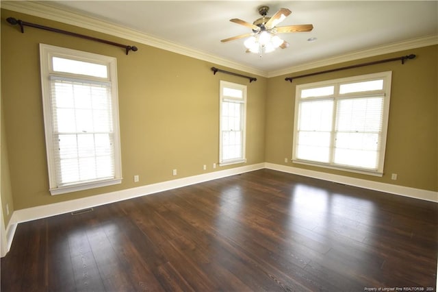 empty room with ceiling fan, dark wood-type flooring, and ornamental molding