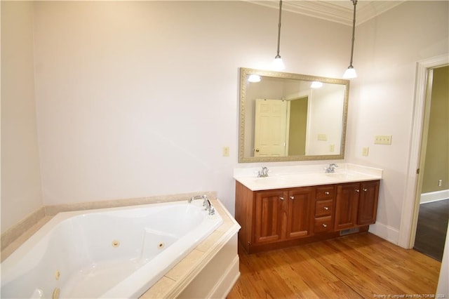 bathroom featuring vanity, hardwood / wood-style flooring, and a relaxing tiled tub