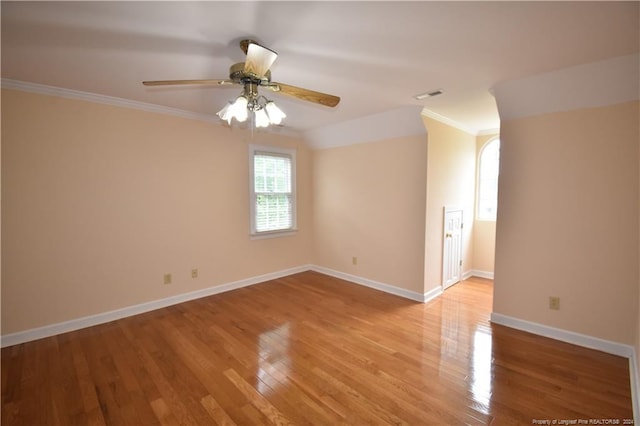 unfurnished room featuring ceiling fan, light hardwood / wood-style floors, ornamental molding, and vaulted ceiling