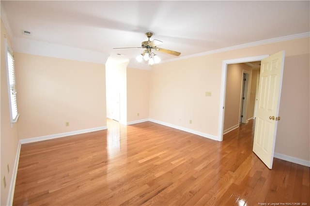 empty room with hardwood / wood-style flooring, ceiling fan, and ornamental molding