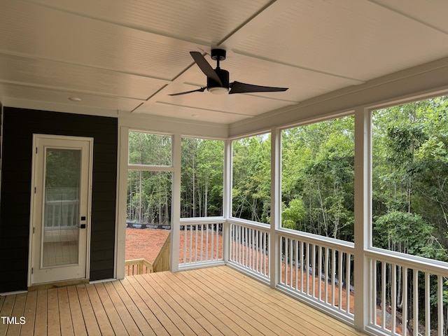 unfurnished sunroom featuring ceiling fan