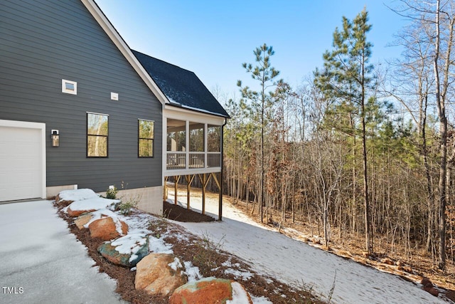 view of property exterior featuring a sunroom