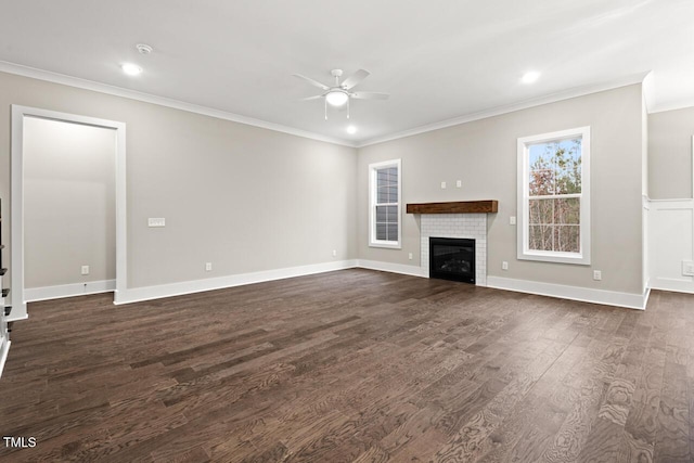 unfurnished living room with a fireplace, ornamental molding, dark hardwood / wood-style floors, and ceiling fan