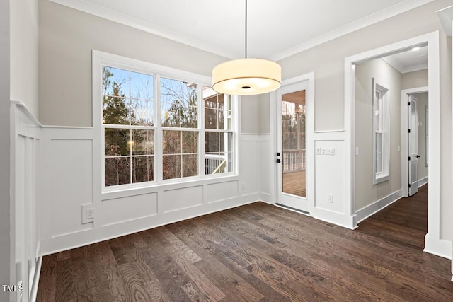 unfurnished dining area with ornamental molding and dark hardwood / wood-style floors