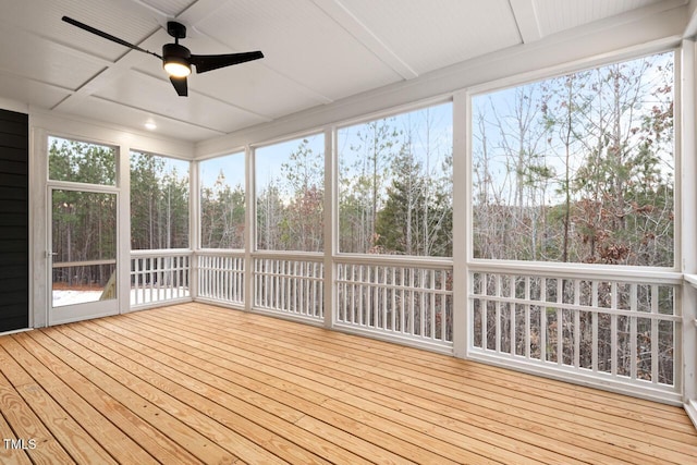 unfurnished sunroom with ceiling fan