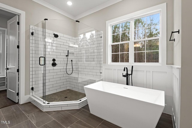 bathroom featuring crown molding and plus walk in shower
