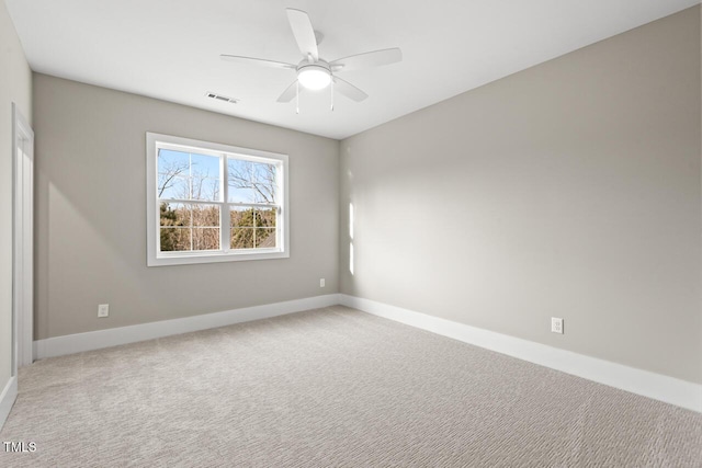 carpeted spare room featuring ceiling fan