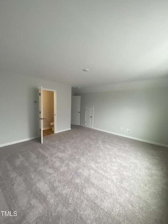 spare room with carpet floors and baseboards