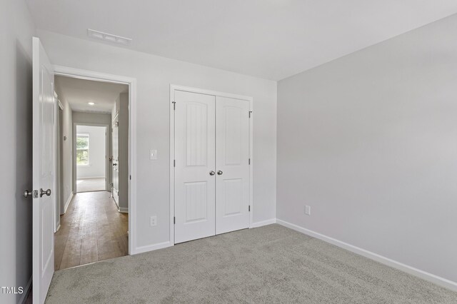 9249 Kitchin Farms Way Unit 432, Wake Forest, NC 27587 - unfurnished bedroom featuring baseboards, carpet floors, and a closet