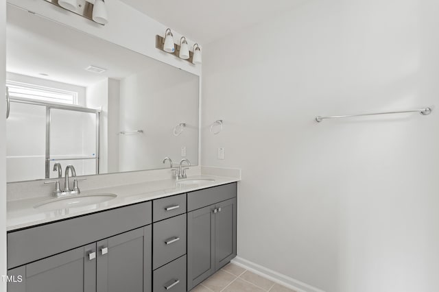 9249 Kitchin Farms Way Unit 432, Wake Forest, NC 27587 - bathroom with double vanity, tile patterned flooring, an enclosed shower, and baseboards