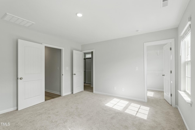 9249 Kitchin Farms Way Unit 432, Wake Forest, NC 27587 - unfurnished bedroom featuring carpet flooring, a spacious closet, and baseboards