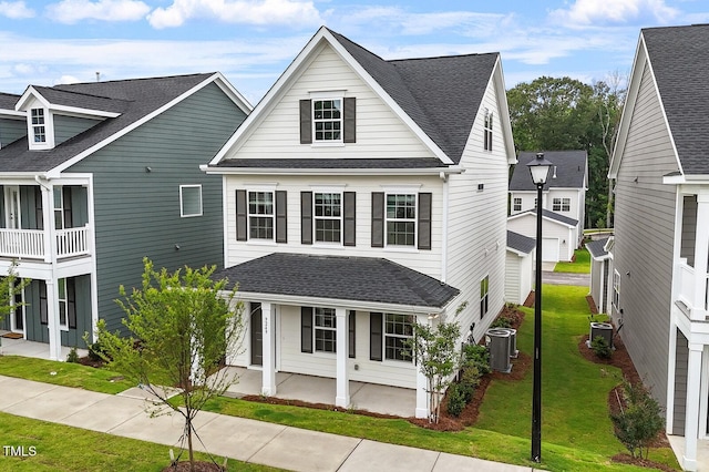 9249 Kitchin Farms Way Unit 432, Wake Forest, NC 27587 - view of front of home with covered porch, a front lawn, a shingled roof, and central air condition unit