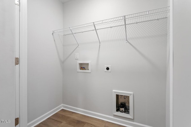 laundry room featuring laundry area, baseboards, wood finished floors, hookup for a washing machine, and electric dryer hookup