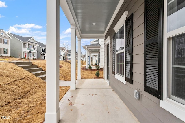 view of patio / terrace with a porch and a residential view