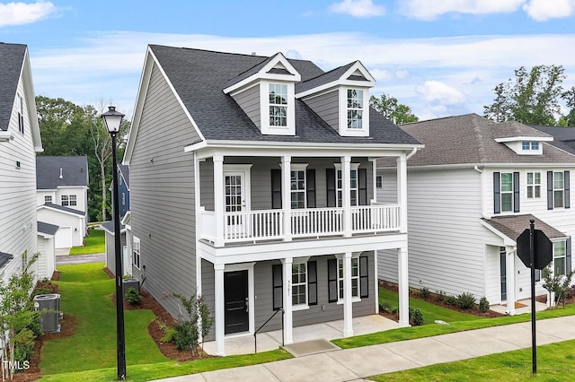 9301 Kitchin Farms Way Unit 433, Wake Forest, NC 27587 - view of front of property with a front yard, a balcony, roof with shingles, cooling unit, and a porch