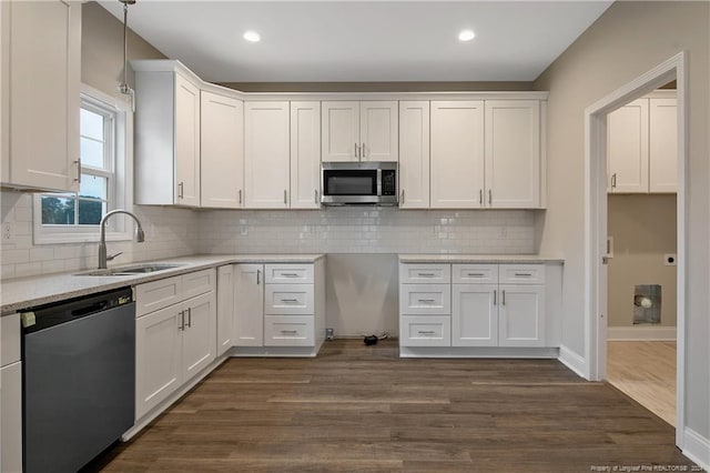 kitchen with dark wood-type flooring, white cabinetry, sink, and stainless steel appliances