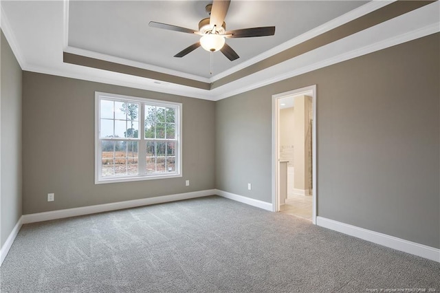 unfurnished room featuring light colored carpet, a raised ceiling, ceiling fan, and crown molding