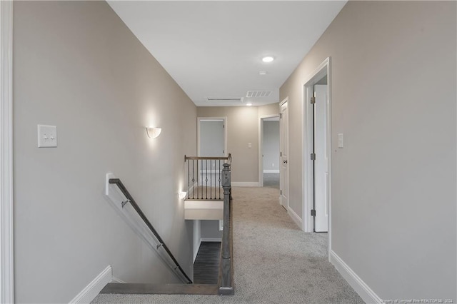 staircase featuring carpet flooring