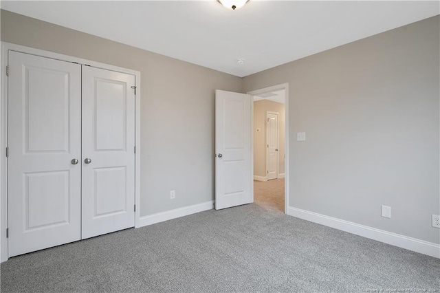 unfurnished bedroom featuring carpet and a closet